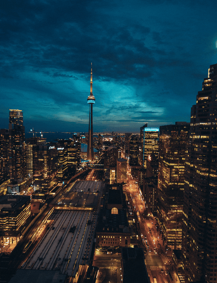 Vibrant Toronto skyline at night with illuminated skyscrapers and glowing city lights